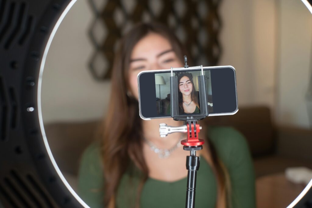 image showing a girl streaming live on youutbe with a mobile camera indicating use of OBS Studio tool