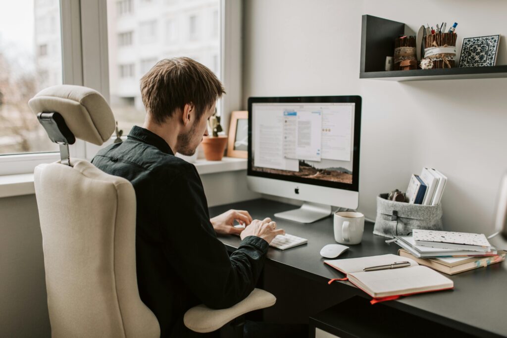 image showing a man doing keword research on computer with keyword tool